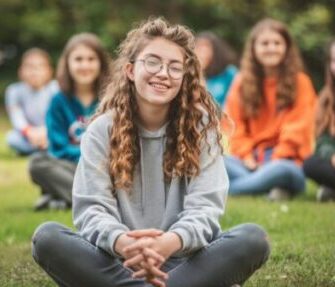 group people sitting grass